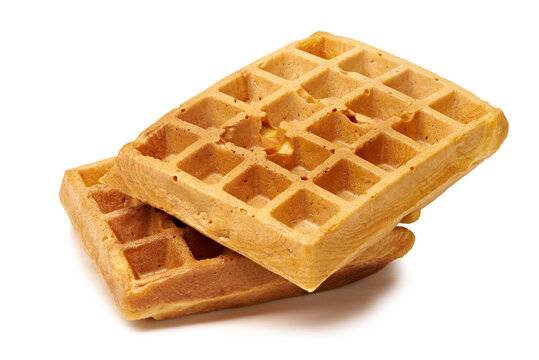 Golden Belgian waffles stacked on white background with crisp texture and grid pattern, with waffle, belgian, breakfast, stacked detail, showing crispy, toasted, golden, grid context
