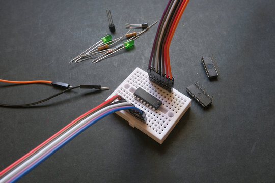 Integrated circuit mounted on the breadboard. Simple electronics projects or electronics education concept.