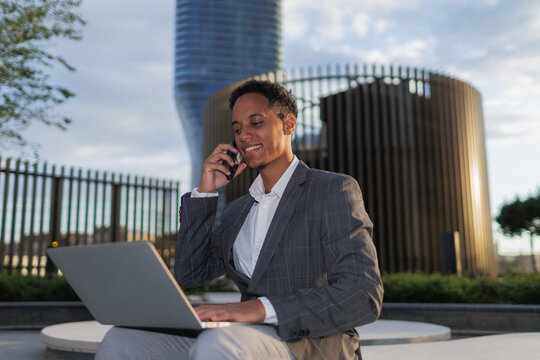 young businessman does outdoor remote work and digital communication
