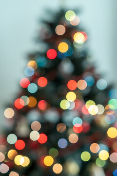 Christmas Tree Silhouette with Cool Blue Bokeh Lights on Light Blue Background
