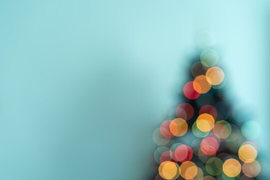 Close Up Christmas Tree Silhouette with Glowing Bokeh Lights and Copy Space