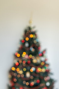 Distant Christmas Tree Silhouette with Red Bokeh Garland Lights and Copy Space