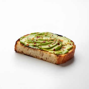 Crusty bread slice with sliced avocado and seasoning on white surface