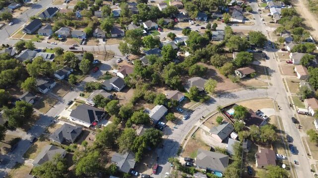 Winding neighborhood lanes divide mature residential properties across DFW Metroplex. Clustered family homes overlook fenced yards dotted with parked motor vehicles, Fort Worth, Texas