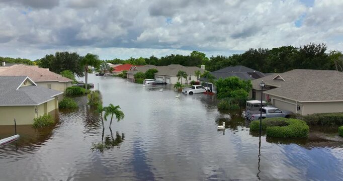 Flooding in Florida caused by tropical storm from hurricane rainfall. Suburb houses in residential community surrounded by flood waters. Aftermath of natural disaster