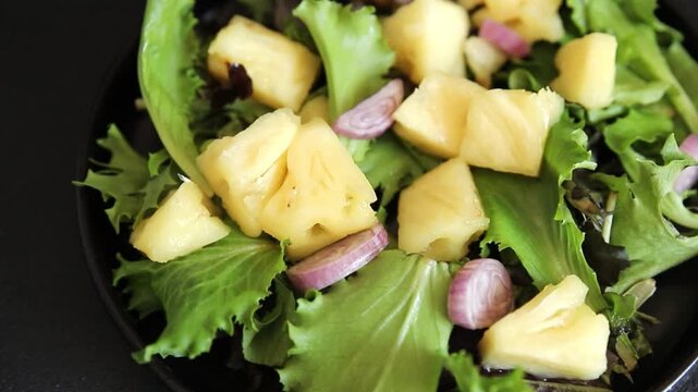 Pineapple salad mixed green salad leaves and pineapple chunks food preparation tasty snack fresh gourmet food background on the table rustic food top view 