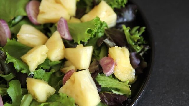 Pineapple salad mixed green salad leaves and pineapple chunks food preparation tasty snack fresh gourmet food background on the table rustic food top view 