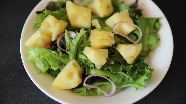 Pineapple salad mixed green salad leaves and pineapple chunks food preparation tasty snack fresh gourmet food background on the table rustic food top view 
