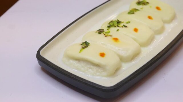 Malai cham cham sweet beautifully placed on white background 