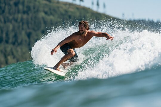 Experienced surfer carving a steep wave for action sports background and coastal adventure banner