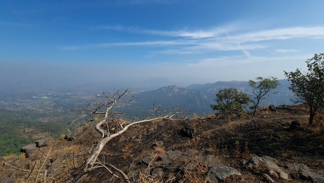 Rocky mountain landscape and forested valley on the Manikgad Fort trek Maharashtra India