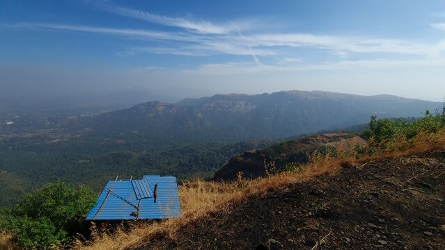 Mountain escarpment and forest valley viewed from Manikgad Fort Maharashtra India