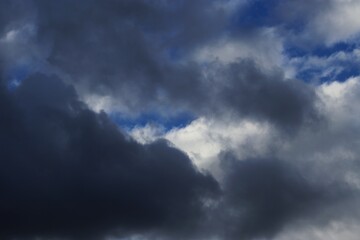 Fototapeta premium Dark storm clouds with patches of blue sky