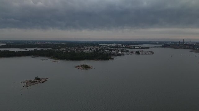 Aerial drone view of Helsinki surrounded by water showing the coastal cityscape islands harbor and Baltic Sea creating a distinctive Nordic urban travel scene