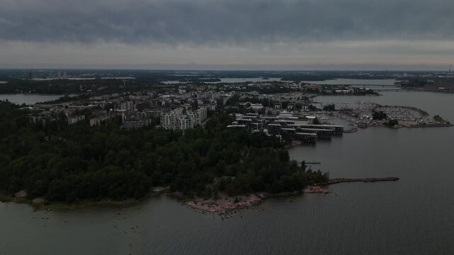 Aerial drone view of a coastal city surrounded by open water with islands harbor and dense urban buildings creating a peaceful Nordic landscape and travel scene