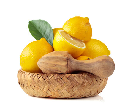 Fresh lemons and wooden juicer isolated on a white background.