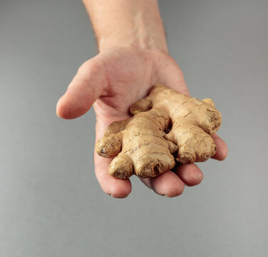 A ginger root in a man's hand.