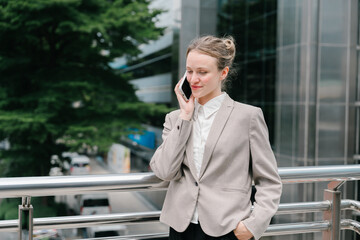 Fototapeta premium The businesswoman conducting business transactions negotiations while feeling calm and focused outdoors near office building