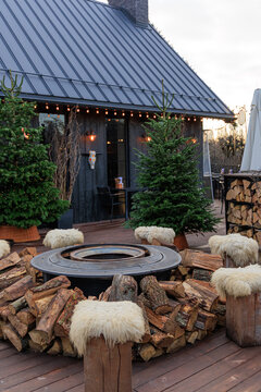 Gathering area with fire pit and wooden seats at cabin in winter