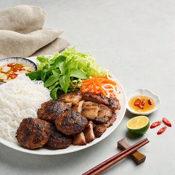 Vietnamese Bun Cha with Grilled Pork Patties and Fresh Herbs, World-Ranked Vietnamese Classic, 45-Degree Angle, Copy Space