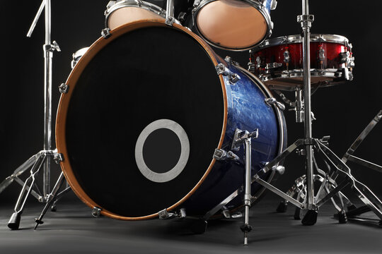 Modern drum set on black background, low angle view