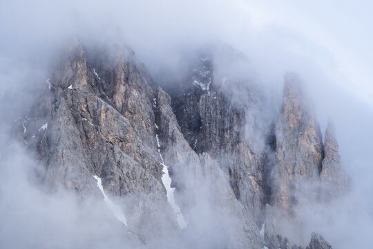 Rock face framed by clouds, Furchetta, Geisler Alm, South Tyrol, Italy