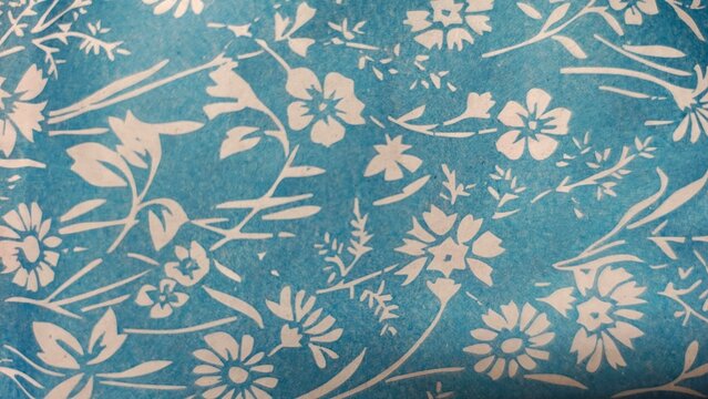 Light blue floral paper texture background with white printed flower motif