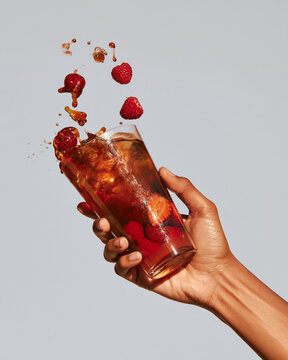 Splashing cocktail drink with fruit. Summer, bright, glossy, editorial style.