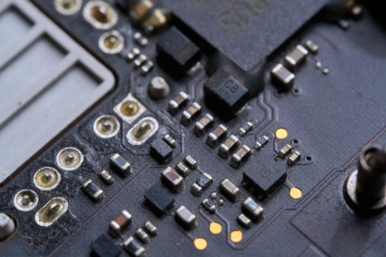 Electronic components mounted on a black circuit board in a computer