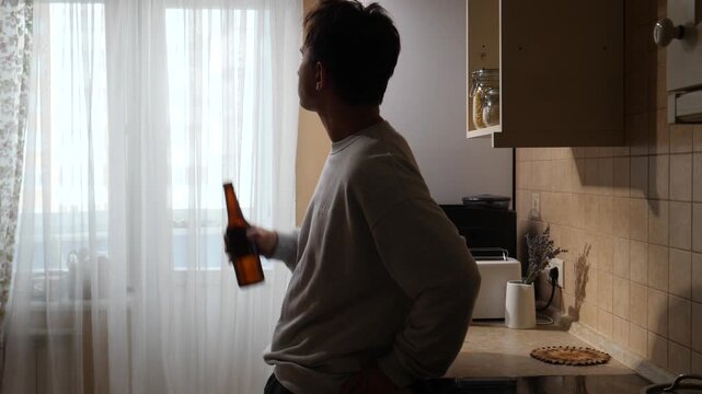 Vertical video man standing in a modern kitchen, viewing a digital recipe on a tablet screen, embodying digital lifestyle and smart home technology while preparing a meal