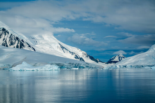 Antarctica, Antarctic Peninsula, cruising in the Lemaire Channel. Ice covered mountain and ice floes in February