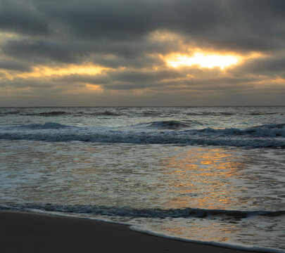 Sun blocked by clouds on the shorea at Pawleys Island
