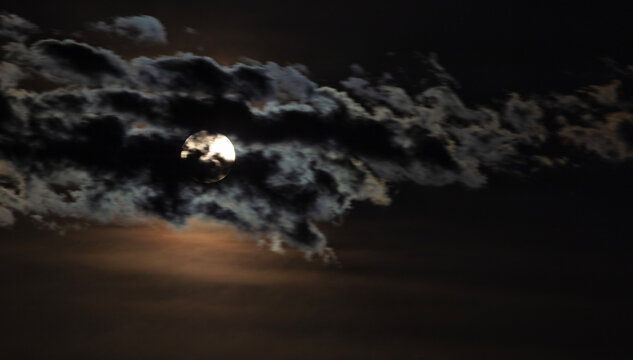 Full moon behind clouds over Hereford Arizona