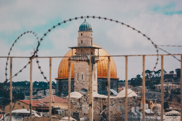 Dome of the Rock behind coils of razor wire © nayefhammouri