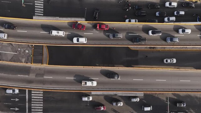 Top-down drone perspective of a fender bender accident stopped on an urban flyover road