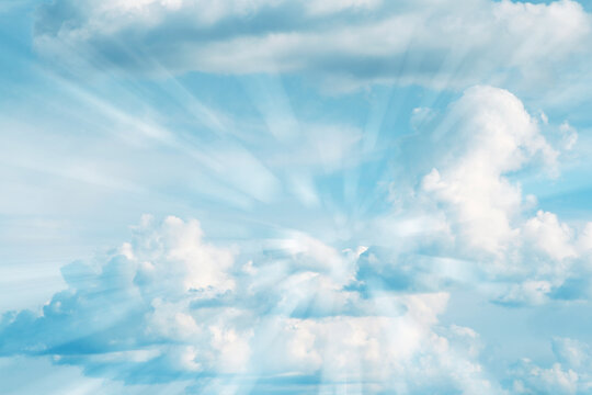 Rays of light shining in heavenly sky clouds