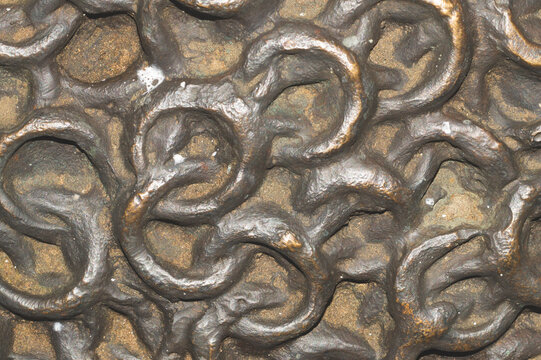 Interlocking metal chainmail rings texture with bronze and rust patina