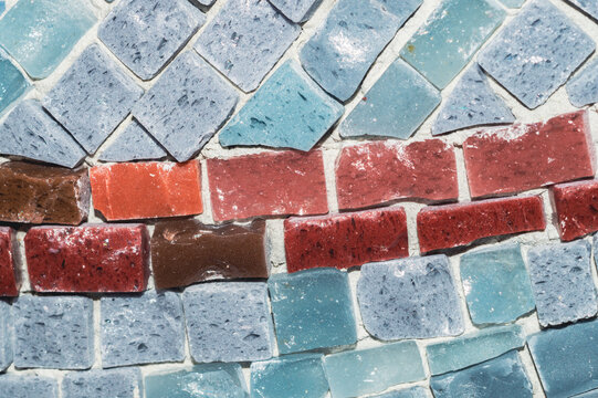 Mosaic texture with blue and red contrasting glass tiles