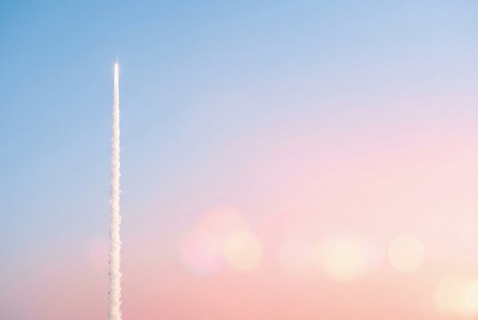 Side profile of a vertical white rocket trail on the left with a bright pastel sunrise sky on the right. Cinematic haze and bokeh for web headers.