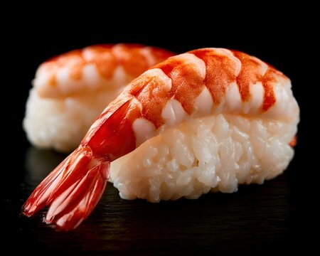 Close up of two delicious Ebi shrimp nigiri sushi on a dark background