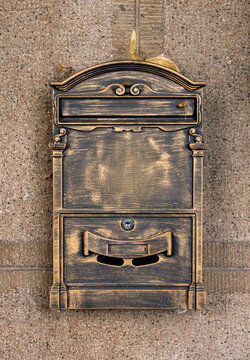 Retro vintage ironwork bronze letter box on building facade outside