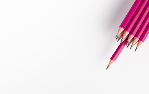 pink colored pencils on white background. sharp pink pencils bunch against. Bunch of colored children's pencils for drawing on the rigth on white background