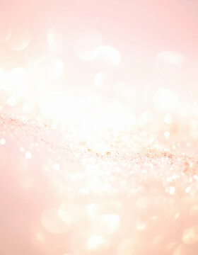 Pink glitter background with sparkling bokeh texture and soft glowing light, creating elegant festive celebration atmosphere for holiday design
