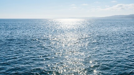 Naklejka premium Tranquil Sunny Ocean Surface Reflecting Bright Seasonal Daylight Ripples Scenic View Surface calm spring sea photo surface sparkling sunshine ocean water sun reflection light shimmer glitter peaceful