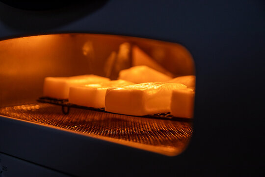 Rice cakes toasting inside glowing toaster oven