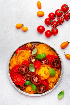 Gourmet fresh tomato salad with red cherry - agriculture harvest concept. Mindful dieting and well-being lifestyle approach. Vibrant summer local farm market vegetables prepared with joy.