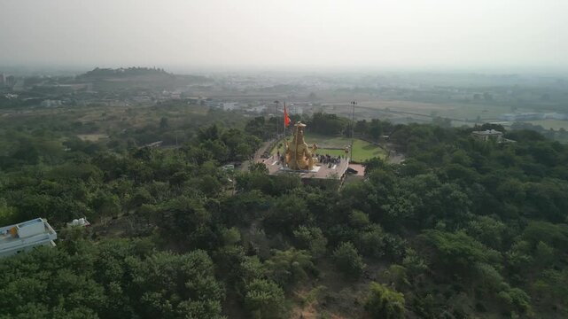 Drone shot orbiting back to left of Pitreshwar Dham temple