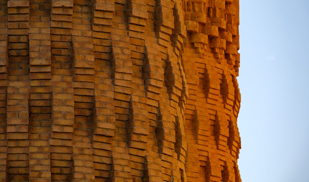 Close-up view of textured weathered brick tower structure and masonry