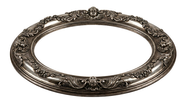 Ornate oval silver picture frame with intricate floral carvings isolated on a black background