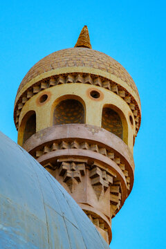 Ornate minaret turret and dome against a clear blue sky architectural heritage